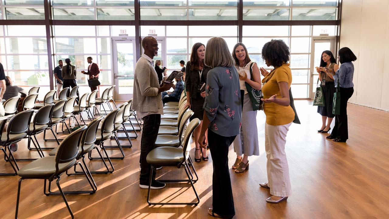 A group of participants networking during the public meeting